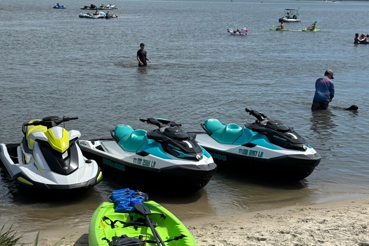 a boat sitting on top of a sandy beach