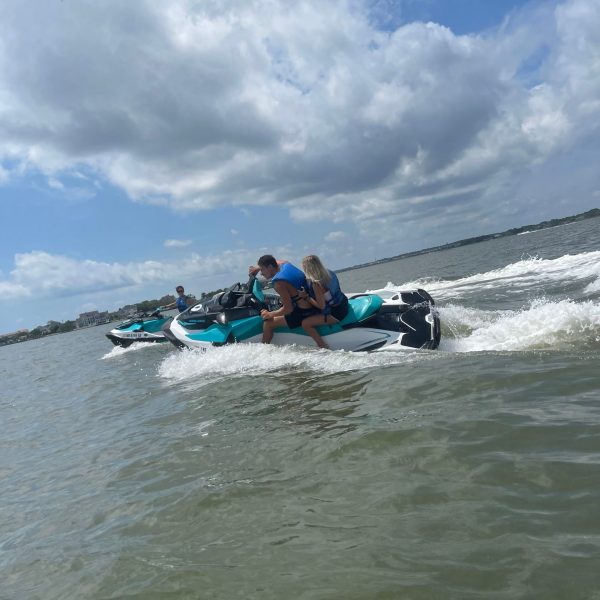 a group of people lying in a body of water