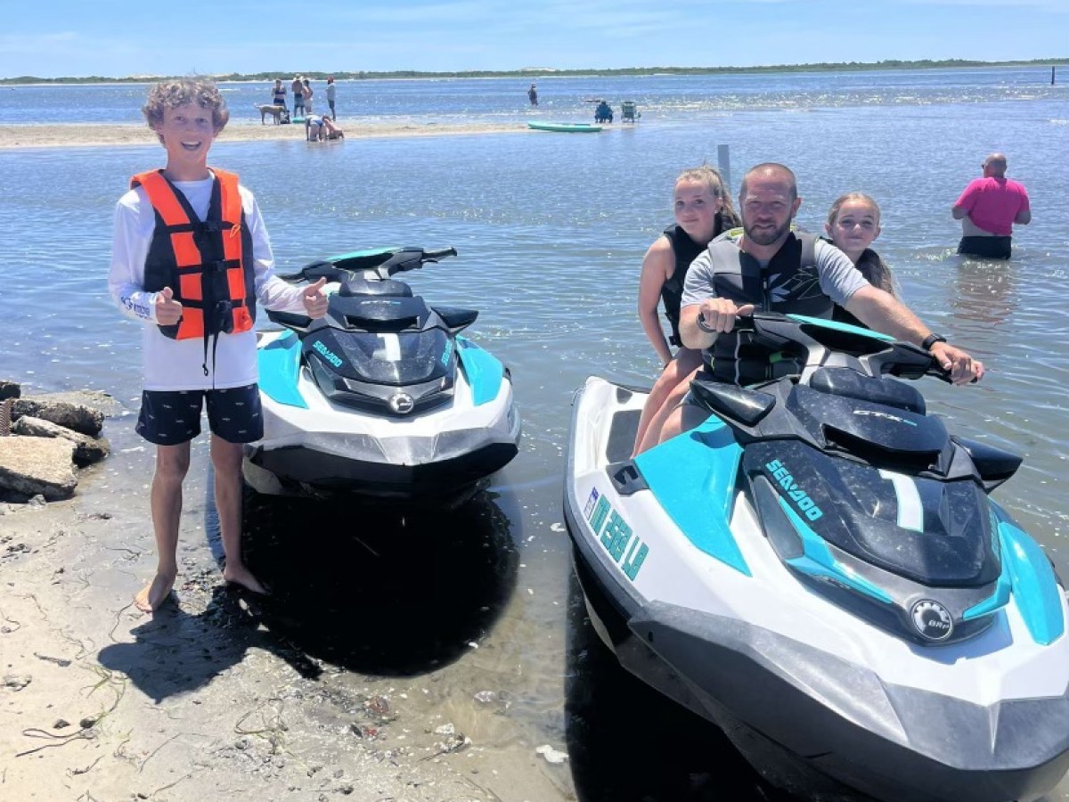 a group of people standing on a boat in the water