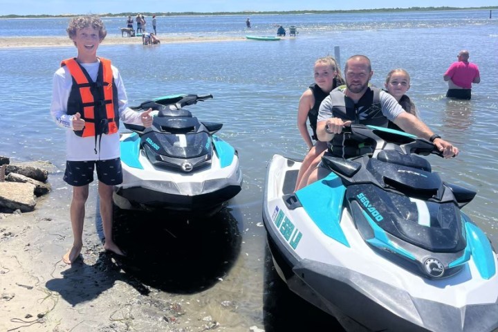a group of people standing on a boat in the water