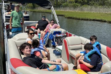 a group of people riding on the back of a boat